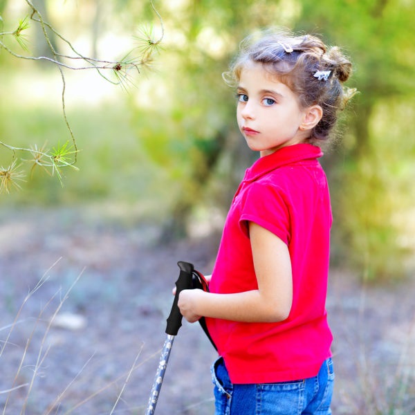 little-girl-with-red-shirt-holding-hiking-pole